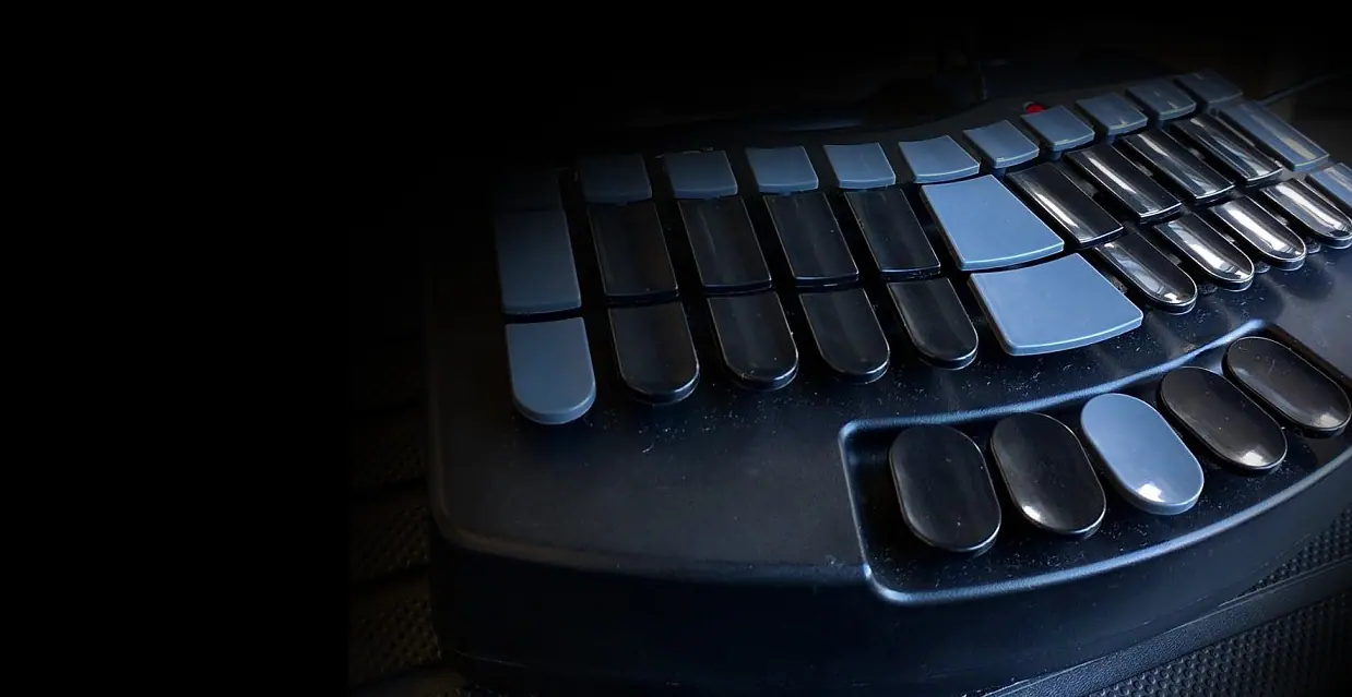 Steno keyboard in soft light, ready for a court reporter to begin a deposition